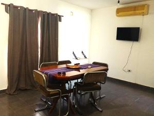 a room with a table with chairs and a television at El Recodo in La Rioja