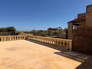 a bridge with a fence on top of a patio at Stella & Stone Guesthouse in Għarb