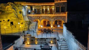 an old building with stairs and tables and lights at Tyana Cave House in Nar