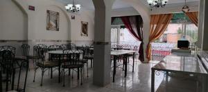 a dining room with tables and chairs and a large window at Alexandross in Puerto Vallarta