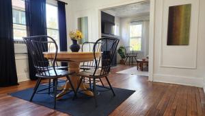 a dining room with a table and four chairs at This Old House in Detroit