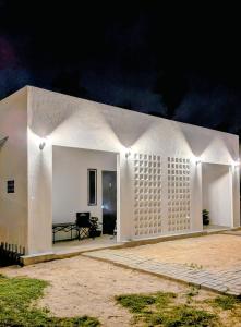a white building with lights on it at night at Zulis Haven Stay in Kuala Rompin +6 photos