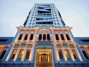 a building with a tall building in the background at CrownPlaza Boutique & Central in Chişinău
