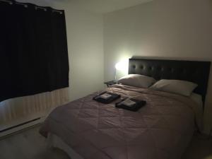 a bedroom with a bed with two books on it at unique Two -Bedroom Central Townhouse in Vancouver