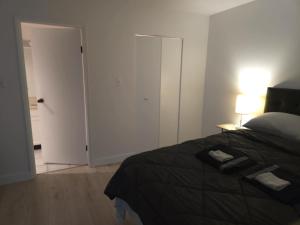 a bedroom with a bed and a door with a lamp at unique Two -Bedroom Central Townhouse in Vancouver