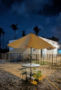 a large yellow umbrella on the beach at Zulis Haven Stay in Kuala Rompin