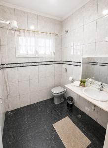 a white bathroom with a toilet and a sink at Loft em Butantã, próximo a USP in São Paulo