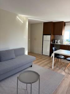a living room with a couch and a table at Casa papillon in Outeiro