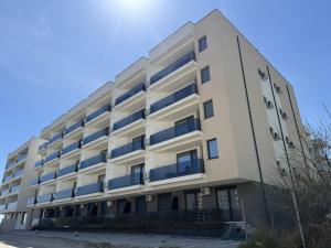 a white building with blue windows at VIBE Apartments in Năvodari