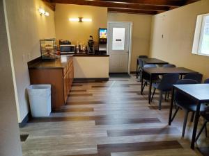 a dining room with tables and chairs and a counter at Bristlecone Motel in Ely