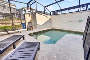 a swimming pool in a building with two benches at 1556 PD - Poolside Bliss: Enchanted 4BR Townhome in Davenport
