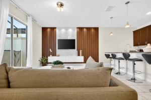 a living room with a couch and a kitchen at 1556 PD - Poolside Bliss: Enchanted 4BR Townhome in Davenport