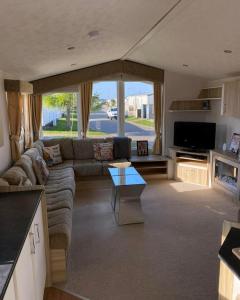 a living room with a couch and a table at 2 bedroom, robin Hood rhyl in Rhyl