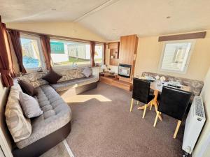 a living room with a couch and a table at 2 bedroom, robin Hood rhyl in Rhyl