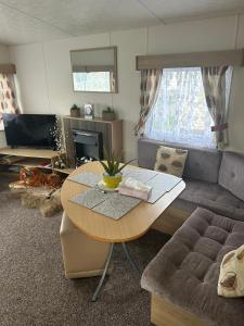 a living room with a table and a couch at 2 bedroom, robin Hood rhyl in Rhyl