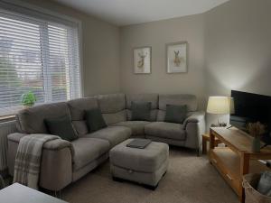 a living room with a couch and a table at West Highland Hideaway in Kinlochleven