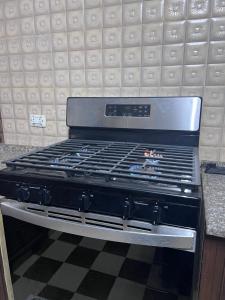 a stove top oven sitting on top of a counter at Saeeds apartment in Ajloun