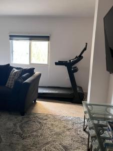 a living room with a couch and a treadmill at Saeeds apartment in Ajloun