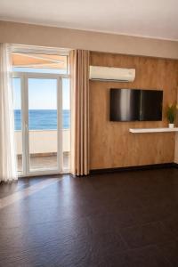 a living room with a view of the ocean at Owen Rooftop in Shëngjin