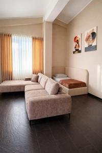 a living room with two beds and a couch at Owen Rooftop in Shëngjin