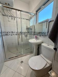 a bathroom with a shower and a toilet and a sink at Owen Rooftop in Shëngjin +42 photos