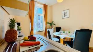 a kitchen with a sink with fruit on a cutting board at FewoZauber "Pension am Dom", Historische Apartments, Superzentral, 7min zum Schloss in Schwerin
