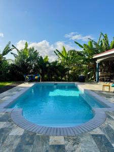 a swimming pool in the middle of a resort at Résidence Terre et Passion in Ducos