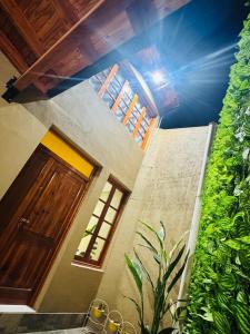 a room with a wooden door and a plant at Refugio Andino in Tupungato
