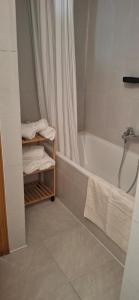 a bathroom with a bath tub and a shower curtain at Casa del Sol Miramar in Miramar