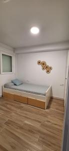 a bedroom with a bed in the corner of a room at Adosado en Casco Antiguo con piscina in Altea +11 photos