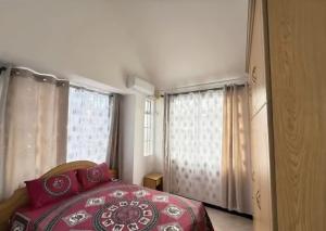 a bedroom with a red bed and a window at Muikora Albion in Albion