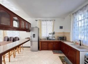 a kitchen with a stainless steel refrigerator and wooden cabinets at Muikora Albion in Albion
