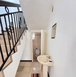 a bathroom with a sink and a staircase at Muikora Albion in Albion +16 photos