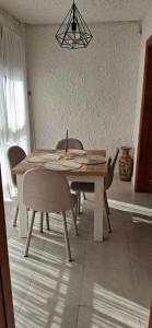 a dining room table and chairs in a room at Casa del Sol Miramar in Miramar