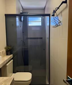 a glass shower in a bathroom with a toilet at Apartamento - Leblon 409 Conforto & Estilo. in Cuiabá +54 photos