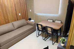 a living room with a couch and a table at Apartamento - Leblon 409 Conforto & Estilo. in Cuiabá