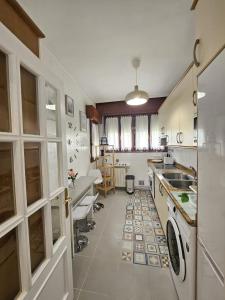 a large kitchen with a sink and a counter at A un paso de Bilbao in Galdakao +23 photos