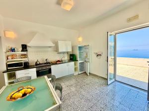 a kitchen with a bowl of bananas on the counter at My Shazzy with amazing Sea View terrace in Praiano