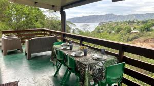 a table and chairs on a balcony with a view at KOKI Horizon in Atuona