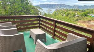 a balcony with chairs and a table and a view at KOKI Horizon in Atuona +8 photos