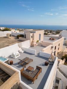 an aerial view of a building with chairs and tables at Amaryllis Suites Santorini in Fira