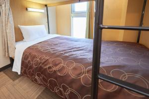 Postel nebo postele na pokoji v ubytování Hotel Select Inn Sano-Ekimae