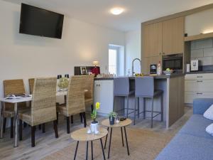 a kitchen and a living room with a blue couch at Jantjes Tuin in Mall