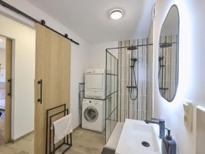 a bathroom with a washing machine and a washer and dryer at Jantjes Tuin in Mall +30 photos