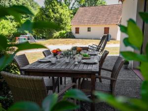 a wooden table with fruits and vegetables on it at Lac Bleu nr 10 in Lacapelle-Marival