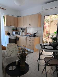 a kitchen with a table and chairs in a room at NiK Seaview Suite Balcony Steps from Beach in Flogita
