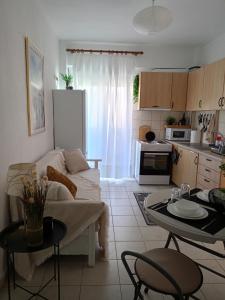 a kitchen and a living room with a couch and a table at NiK Seaview Suite Balcony Steps from Beach in Flogita +44 photos