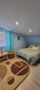 a bedroom with two beds and a rug on the floor at Duchniczowe in Prusie