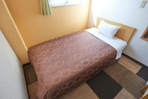 Postel nebo postele na pokoji v ubytování Hotel Select Inn Sano-Ekimae