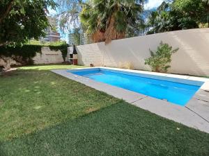 a swimming pool in a yard next to a fence at Casa Verde 3 in Godoy Cruz